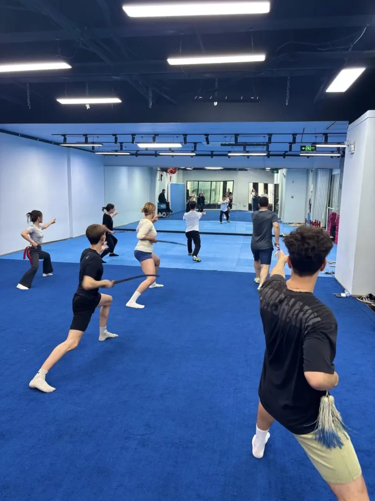 group of au pair student at a Kungfu event swords in China Chengdu with Masons Au Pair