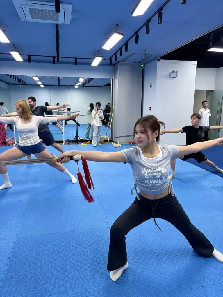group of au pair student at a Kungfu event swords in China Chengdu with Masons Au Pair